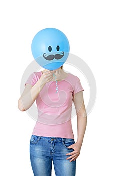 girl in jeans and a t-shirt holds a balloon in her hands that covers her face. White isolate