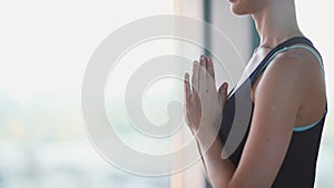 Girl join palms in front of chest level. Hands in prayer pose