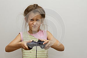 Girl with joystick. Excited little girl playing video game and smiling