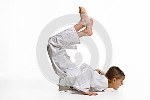 Girl judo student performs warm-up