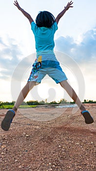 Girl jump on the sky under sunset light