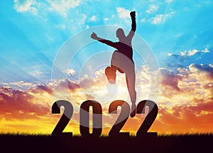 Girl jump to the New Year 2022 at sunset.