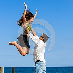 Girl jumping into boys arms