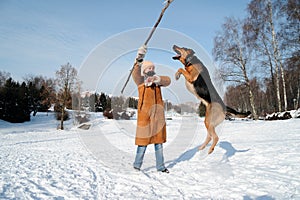Girl with jumping dog against blue sky