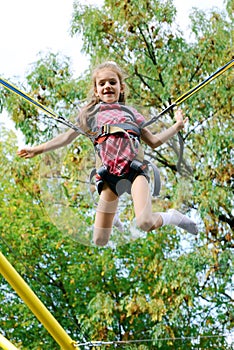 Girl jumping on elastic bands