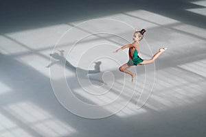 Girl jumping gymnast trains in sports school