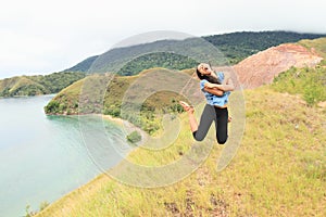 Girl jumping high above bay