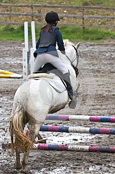 Girl jumping on a horse.