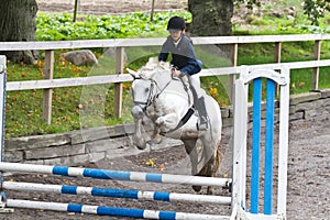 Girl jumping on a horse.