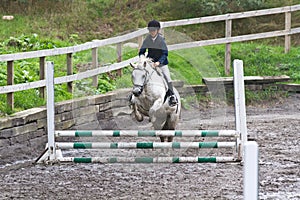 Girl jumping on a horse.