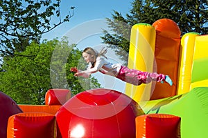 Girl Jumping on an Inflate Ball photo