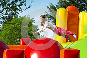 Girl Jumping on an Inflate Castle photo