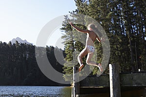 Girl Jumping From Jetty Into Lake