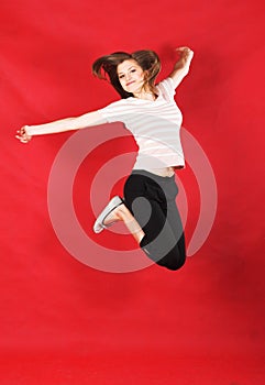 Girl jumping of joy over red