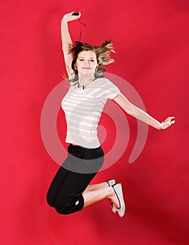 Girl jumping of joy over red