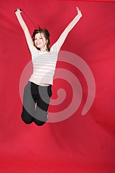 Girl jumping of joy over red