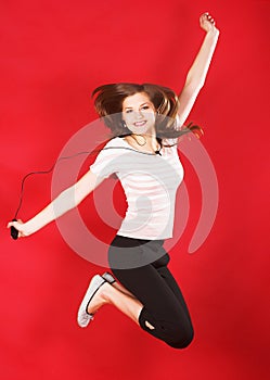 Girl jumping of joy over red