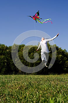 Girl jumping with Kite