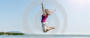 Girl jumping on the lake