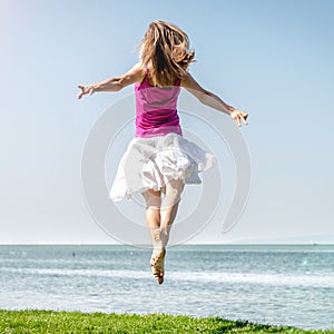 Girl jumping on the lake