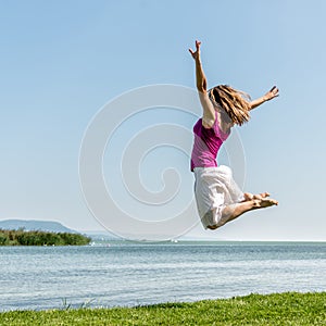 Girl jumping on the lake