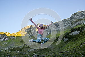 Girl jumping in the mountains