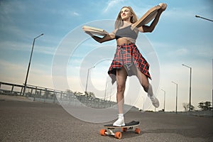 Girl jumping off a skateboard with headphonesGirl neither skateboard or longboard delivers pizza in the city