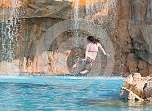 Girl jumping into pool