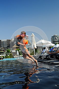 Girl jumping into pool