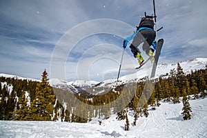 Girl jumping on randonee skiis photo