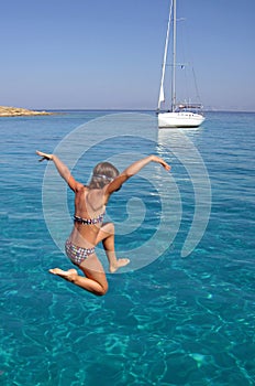 Girl jumping in sea