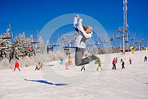 Girl jumping on ski slope