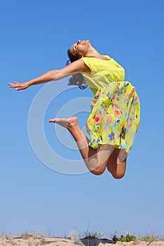 Girl jumping in summer dress