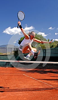 Girl jumping tennis net