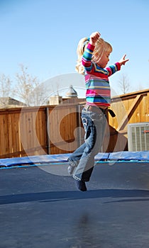 Girl jumping on trampoline