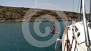 Girl jumping from yacht into sea
