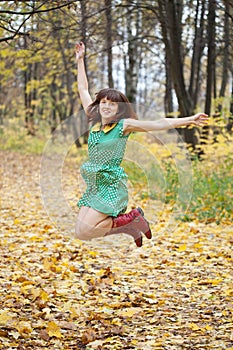 Girl jumps in autumn