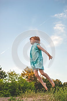 The girl jumps high, as if flying