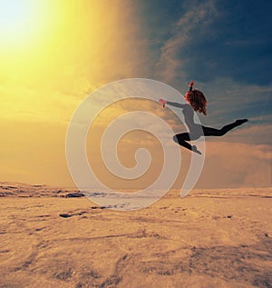 Girl jumps high in the beautiful posture