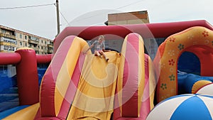 Girl jumps on inflatable trampoline