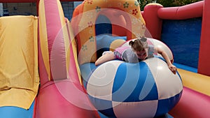 Girl jumps on inflatable trampoline