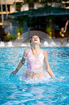 Girl jumps out of a swimming pool