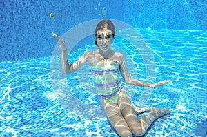 Girl jumps and swims in pool underwater