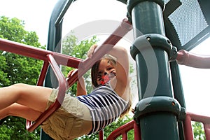 Girl on jungle gym at playground