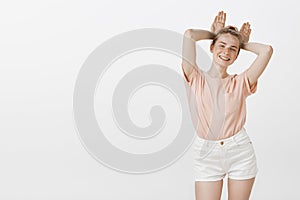 Girl just wanna have fun. Portrait of happy playful cute woman in pink t-shirt and trendy shirts, smiling broadly