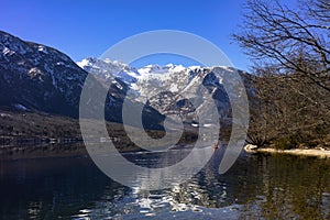 Girl is kayaking in a lake Bohinj, Slovenia