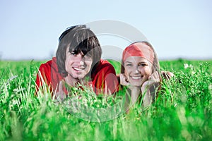 Girl in kerchief with boy on grass photo