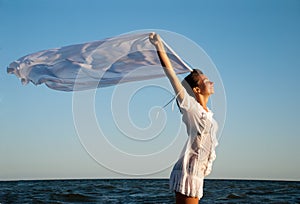 Girl with kerchief on the sunset.