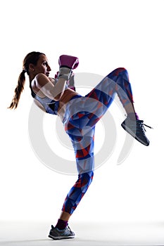 Girl kickboxer posing with pink gloves