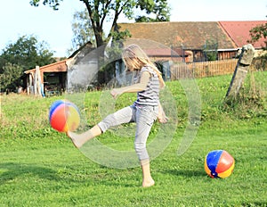 Girl kicking inflating balls